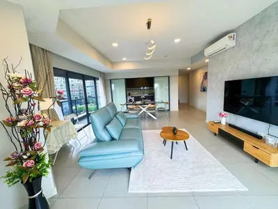 a living room with a blue couch and a tv at The Atrium Jalan Ampang Elegant Fully Air-Con 3 BR Homestay in Kuala Lumpur