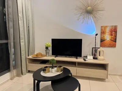 a living room with a tv and a table at Robertson S23A KLCC Bukit Bintang Jalan Alor Petaling Street 2R 7Pax in Kuala Lumpur
