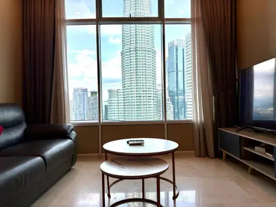 a living room with a couch and a table and a large window at Apartment KL Luxury Home Stay in Kuala Lumpur