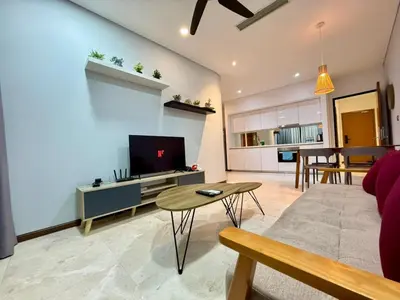 a living room with a couch and a tv and a table at Apartment KL Luxury Home Stay in Kuala Lumpur