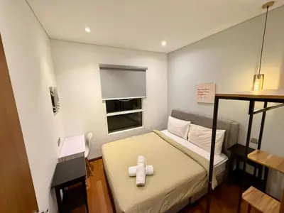 a small room with a bed with a white cross on it at Apartment KL Luxury Home Stay in Kuala Lumpur