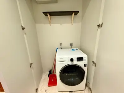 a washer and dryer in a small room at Apartment KL Luxury Home Stay in Kuala Lumpur