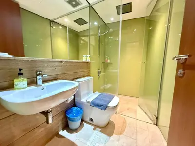 a bathroom with a sink and a toilet and a shower at Apartment KL Luxury Home Stay in Kuala Lumpur