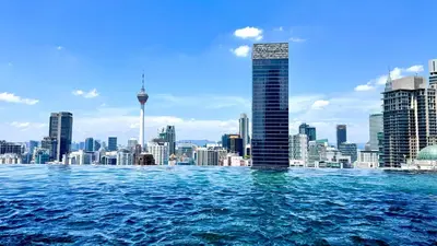 a view of the sydney city skyline from a swimming pool at Bukit Bintang Axon Residence By TRX in Kuala Lumpur