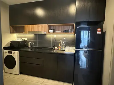 a kitchen with a black refrigerator and a washer at Bukit Bintang Axon Residence By TRX in Kuala Lumpur