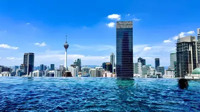 a view of the sydney city skyline from a swimming pool at Bukit Bintang Axon Residence By TRX in Kuala Lumpur