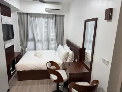 a bedroom with a bed and a mirror and a desk at Agile Bukit Bintang By ERYSHAH in Kuala Lumpur