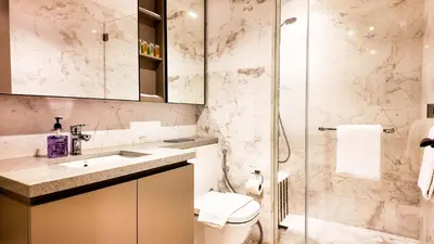 a bathroom with a shower and a toilet and a sink at Eaton Residence KLCC - Royal Home in Kuala Lumpur