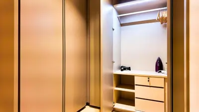 a bathroom with a closet with a sink and a mirror at Eaton Residence KLCC - Royal Home in Kuala Lumpur