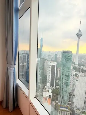 a view of a city skyline from a window at Sky Suites KLCC by Apartment TD Luxury in Kuala Lumpur