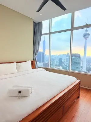 a bedroom with a large bed with a large window at Sky Suites KLCC by Apartment TD Luxury in Kuala Lumpur