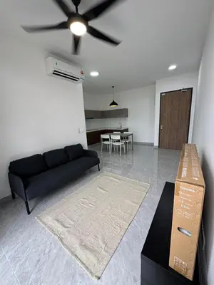 a living room with a black couch and a table at star resdence in Kuala Lumpur