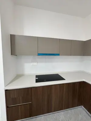 a kitchen with a white counter top and brown cabinets at star resdence in Kuala Lumpur