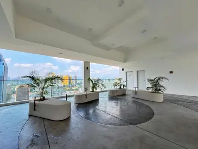 a large room with plants on the floor of a building at KLCC View Majestic Lovely Studio with Rooftop Pool in Kuala Lumpur