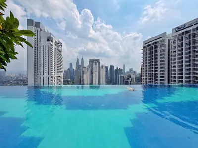 a large swimming pool on top of a city skyline at KLCC View Majestic Lovely Studio with Rooftop Pool in Kuala Lumpur
