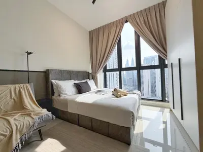 a bedroom with a bed with a teddy bear on it at KLCC View Majestic Lovely Studio with Rooftop Pool in Kuala Lumpur