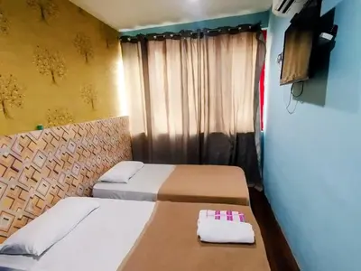a room with two beds and a tv in it at Cahaya Hanson BilikXpert in Kuala Lumpur