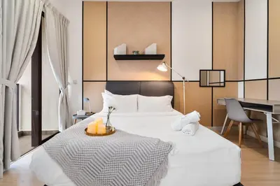 a bedroom with a large white bed and a desk at Continew Residence 10MIN To KLCC With Board Games Fit Up To 6PAX in Kuala Lumpur