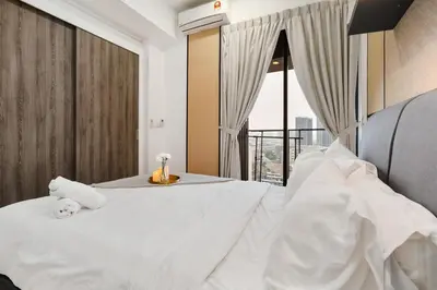 a bedroom with a large white bed with a window at Continew Residence 10MIN To KLCC With Board Games Fit Up To 6PAX in Kuala Lumpur