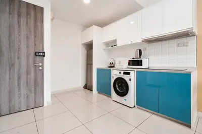 a kitchen with a washing machine and a door at Continew Residence 10MIN To KLCC With Board Games Fit Up To 6PAX in Kuala Lumpur