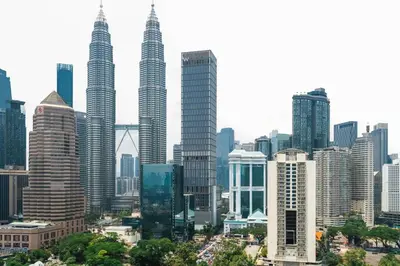 a city skyline with tall skyscrapers at Legasi Residence Direct KLCC VIEW Only10minWalkToKLCC With PS4 AndBoardGames in Kuala Lumpur