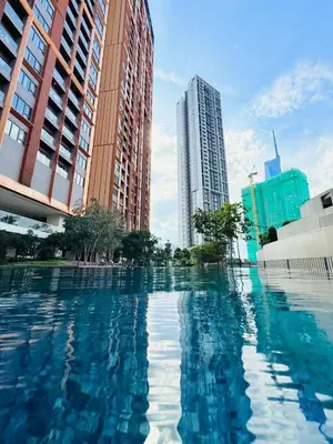 a pool of water in a city with tall buildings at Lucentia Residence in Kuala Lumpur
