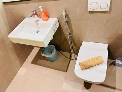 a bathroom with a white sink and a toilet at Lucentia Residence in Kuala Lumpur