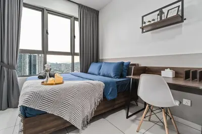 a bedroom with a blue bed and a chair at Kenwingston Platz 15 MINS TO KLCC Fit 5 Pax With Board games in Kuala Lumpur