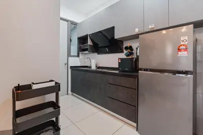 a small kitchen with a stainless steel refrigerator at Kenwingston Platz 15 MINS TO KLCC Fit 5 Pax With Board games in Kuala Lumpur