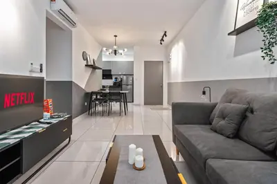 a living room with a couch and a table at Kenwingston Platz 15 MINS TO KLCC Fit 5 Pax With Board games in Kuala Lumpur