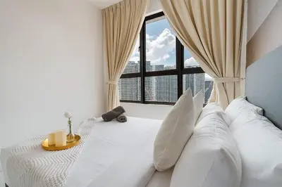 a bedroom with a white bed with a large window at Luxury 3Bedroom Kenwingston Platz 15Mins To KLCC Fit 9Pax A15 in Kuala Lumpur