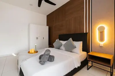 a bedroom with a white bed with a gray pillow on it at Kenwingston Platz 15Mins To KLCC Fit 9Pax Modern Interior B25 in Kuala Lumpur