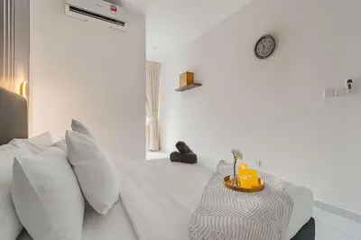 a white bedroom with a bed with white pillows at Kenwingston Platz 15MINS TO KLCC Modern Interior Boardgames A26 in Kuala Lumpur
