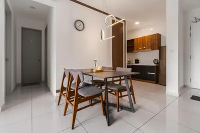 a kitchen and dining room with a table and chairs at Kenwingston Platz Facing KLCC VIEW 15Mins To KLCC Fit 9Pax A24 in Kuala Lumpur