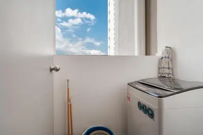 a washing machine in a room with a window at Kenwingston Platz Facing KLCC VIEW 15Mins To KLCC Fit 9Pax A24 in Kuala Lumpur