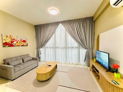 a living room with a couch and a tv at Majestic Residence KLCC By MYHOME in Kuala Lumpur