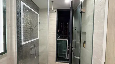 a shower with a glass door in a bathroom at Star Residance KLCC By Nexus 24 in Kuala Lumpur