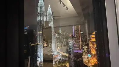 a view of a city skyline from a window at Star Residance KLCC By Nexus 24 in Kuala Lumpur
