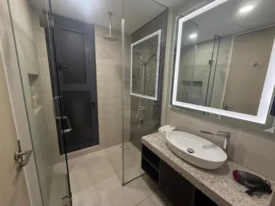 a bathroom with a sink and a shower with a mirror at Star Residance KLCC in Kuala Lumpur