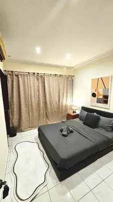 a bedroom with a bed and a large window at Cozy Private Room in Taman Desa Shared Bathroom in Kuala Lumpur