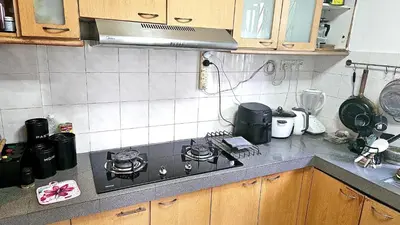 a kitchen with a stove top oven in a kitchen at Cozy Private Room in Taman Desa Shared Bathroom in Kuala Lumpur