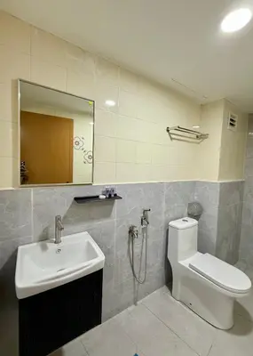 a bathroom with a sink and a toilet and a mirror at Hotel Putra Hills in Kuala Lumpur