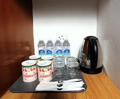 a tray with bottles of water and glasses on a counter at Hotel Putra Hills in Kuala Lumpur