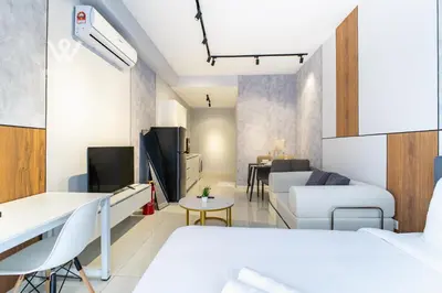 a small room with a bed and a living room at Modern & Minimalist Studio at Majestic Residence KL in Kuala Lumpur