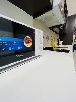 a microwave on a kitchen counter with a pizza on it at Majestic Residence Kuala lumpur by Luxury in Kuala Lumpur