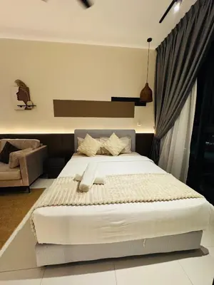 a bedroom with a bed and a chair at Majestic Residence Kuala lumpur by Luxury in Kuala Lumpur