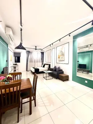 a living room with a table and a couch at Klcc Suites 1 By Chambers RMS in Kuala Lumpur