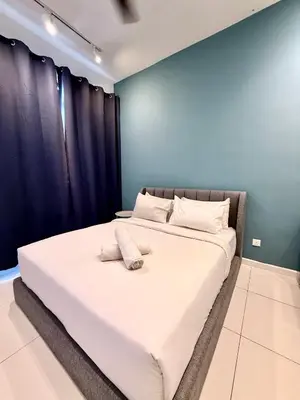 a bed with two pillows on it in a room at Klcc Suites 1 By Chambers RMS in Kuala Lumpur