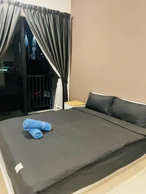 a bed with a blue towel on top of it at Klcc Suites 1 By Chambers RMS in Kuala Lumpur