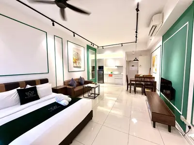 a living room with a bed and a dining room at Klcc Suites 1 By Chambers RMS in Kuala Lumpur